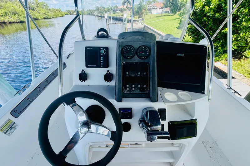 Slide: The Image of Steering console of a 2006 Boston Whaler 230 Dauntless boat, featuring navigation equipment. - 15