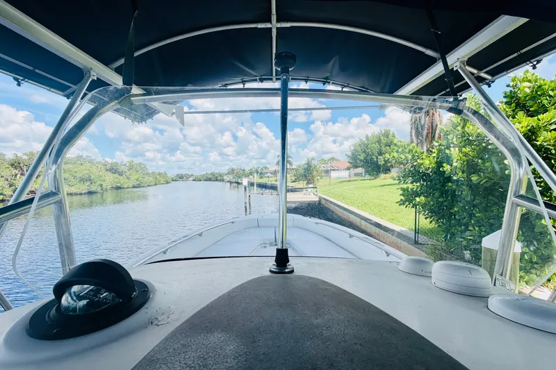 Slide: The Image of Boston Whaler 230 Dauntless 2006 on a scenic river with lush greenery. - 17