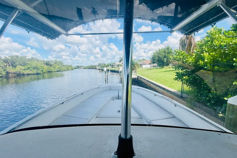 Slide: The Image of Boston Whaler 230 Dauntless 2006 on a scenic river with lush greenery. - 18