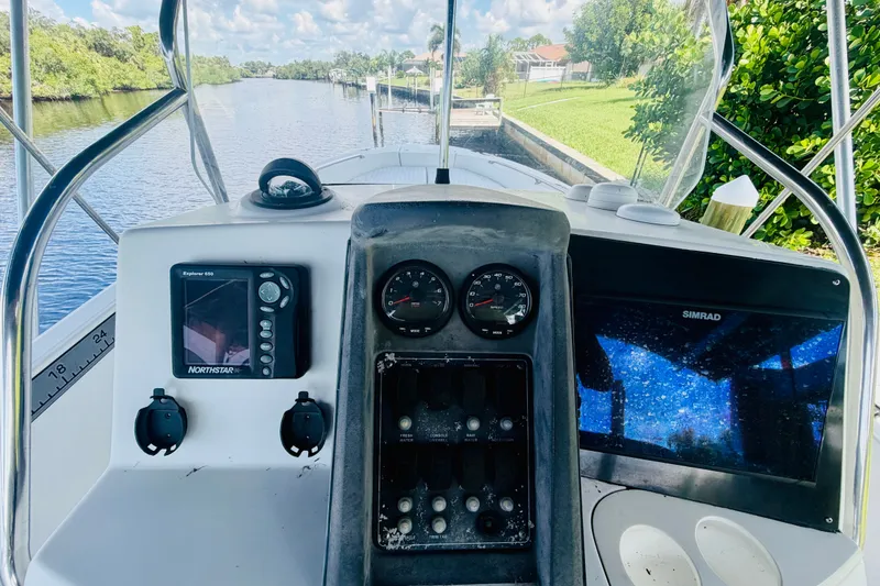 Slide: The Image of 2006 Boston Whaler 230 Dauntless boat dashboard with navigation equipment and gauges. - 16