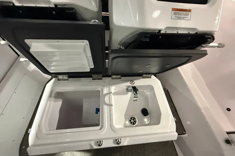 Slide: The Image of 2025 Axopar 29 XC Cross Cabin interior sink and storage compartments. - 13