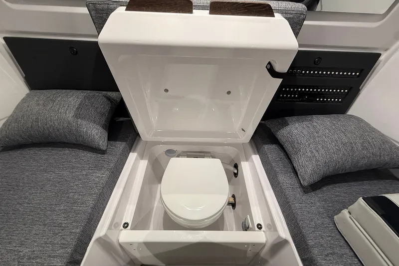 Slide: The Image of 2025 Axopar 29 XC Cross Cabin interior with hidden toilet feature. - 15
