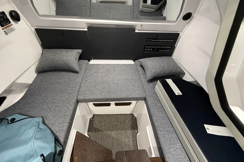 Slide: The Image of 2025 Axopar 29 XC Cross Cabin interior with gray cushions and modern design. - 14