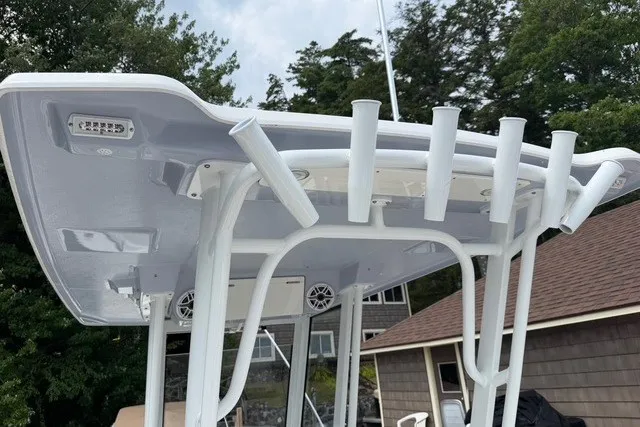 Slide: The Image of 2026 Robalo R270 Center Console boat with rod holders and speakers on the T-top. - 24
