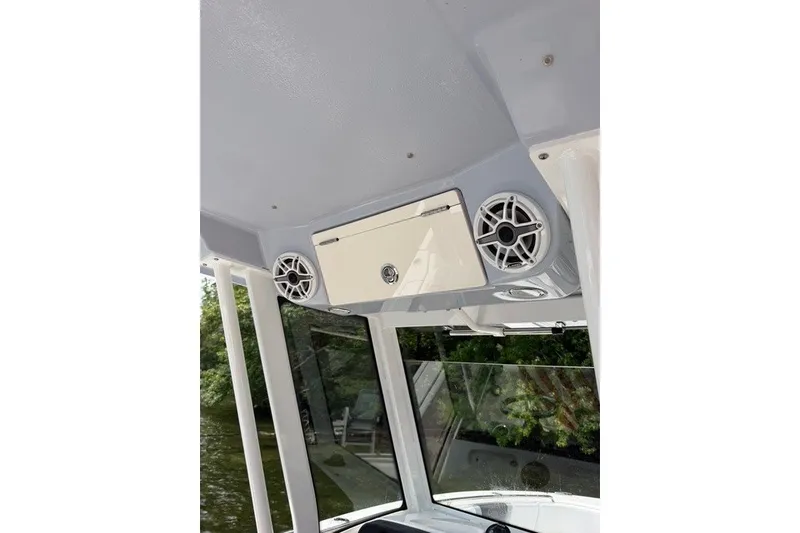 Slide: The Image of 2026 Robalo R270 Center Console boat interior with speakers and storage compartment. - 21