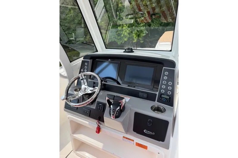 Slide: The Image of 2026 Robalo R270 Center Console helm with dual displays and modern controls. - 14