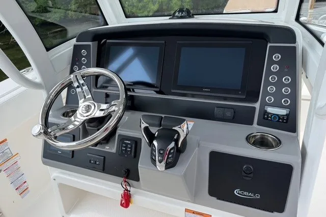 Slide: The Image of 2026 Robalo R270 Center Console helm with dual displays and modern controls. - 15