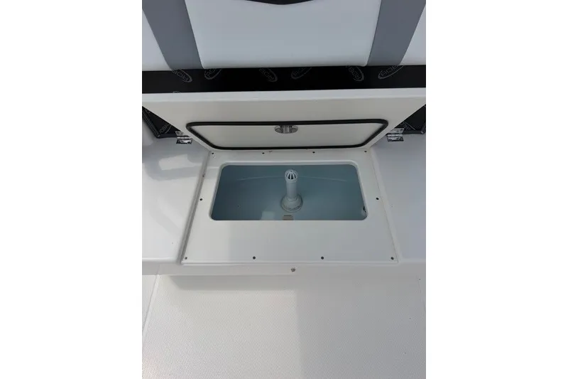 Slide: The Image of 2026 Robalo R270 Center Console boat storage compartment with open lid. - 43