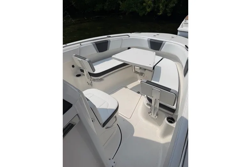 Slide: The Image of 2026 Robalo R270 Center Console boat interior with seating and table. - 33