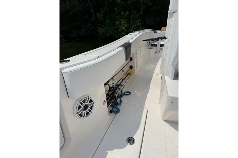 Slide: The Image of 2026 Robalo R270 Center Console boat interior with fishing rod storage. - 28