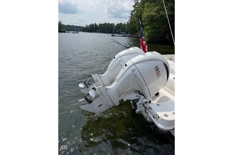 Slide: The Image of 2026 Robalo R270 Center Console with dual Yamaha outboard motors on a lake. - 4