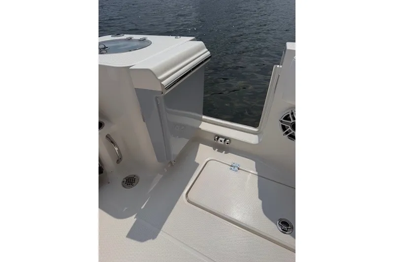 Slide: The Image of 2026 Robalo R270 Center Console boat interior with open hatch and water view. - 30
