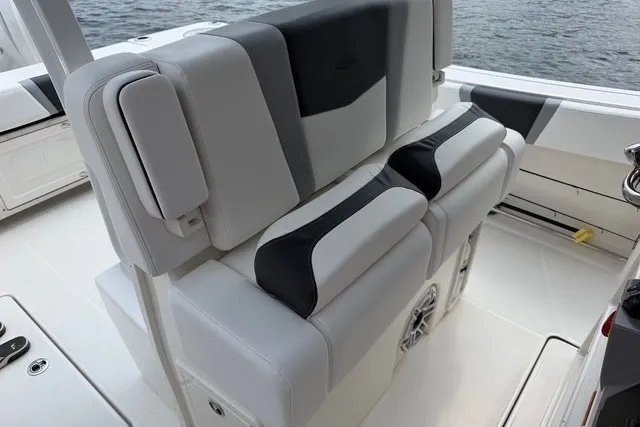 Slide: The Image of 2026 Robalo R270 Center Console boat interior with stylish seating and ocean backdrop. - 13