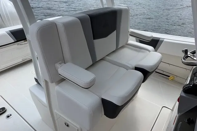 Slide: The Image of 2026 Robalo R270 Center Console boat seating, featuring plush white and gray upholstery. - 12