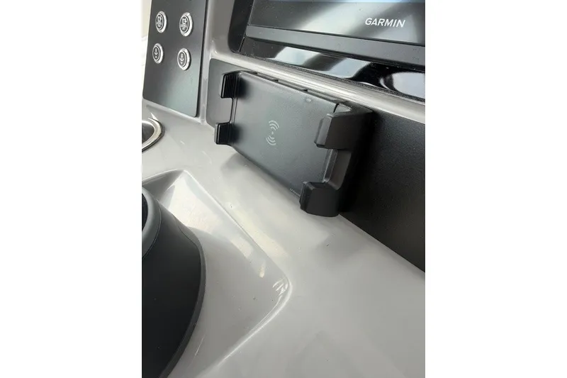 Slide: The Image of 2026 Robalo R270 Center Console dashboard with Garmin display and phone holder. - 18