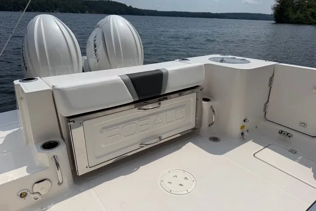 Slide: The Image of 2026 Robalo R270 Center Console boat with dual Yamaha engines on a lake. - 25