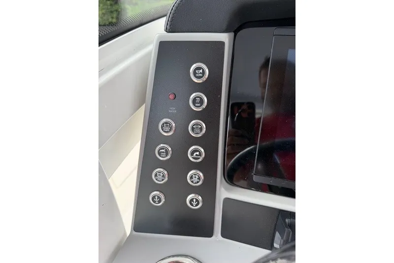Slide: The Image of 2026 Robalo R270 Center Console dashboard with control buttons and display screen. - 19