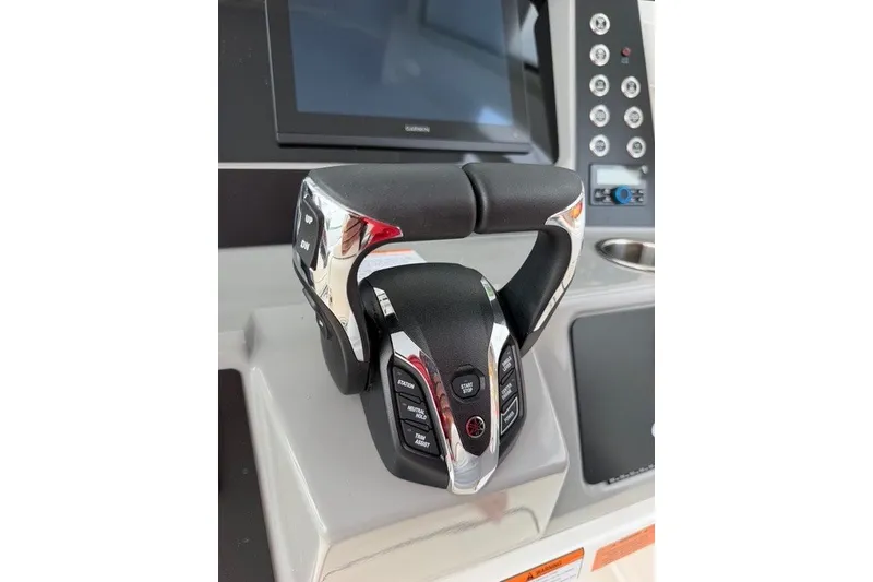Slide: The Image of 2026 Robalo R270 Center Console helm with advanced controls and display screen. - 16