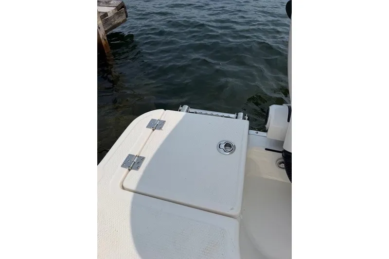 Slide: The Image of 2026 Robalo R270 Center Console boat deck near water. - 40