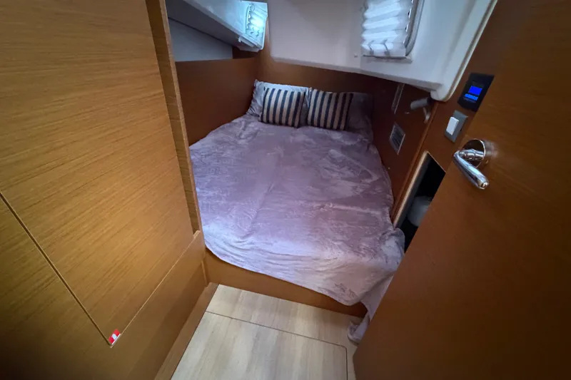 Slide: The Image of Cozy cabin interior of 2024 Jeanneau Sun Odyssey 410 sailboat with plush bedding. - 21