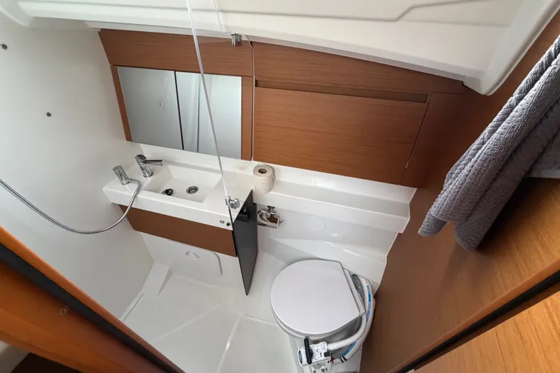 Slide: The Image of 2024 Jeanneau Sun Odyssey 410 bathroom with modern fixtures and wooden accents. - 18