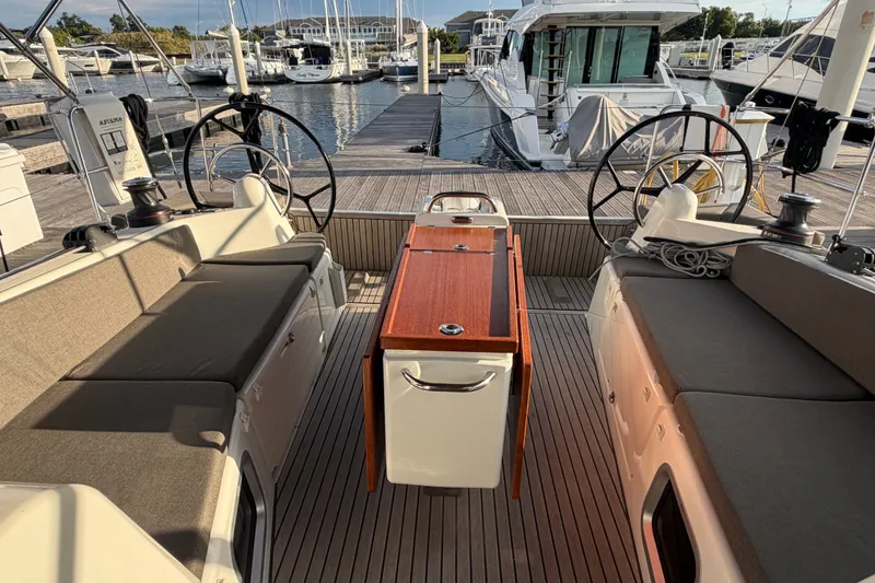 Slide: The Image of 2024 Jeanneau Sun Odyssey 410 yacht cockpit with dual steering wheels and seating. - 30