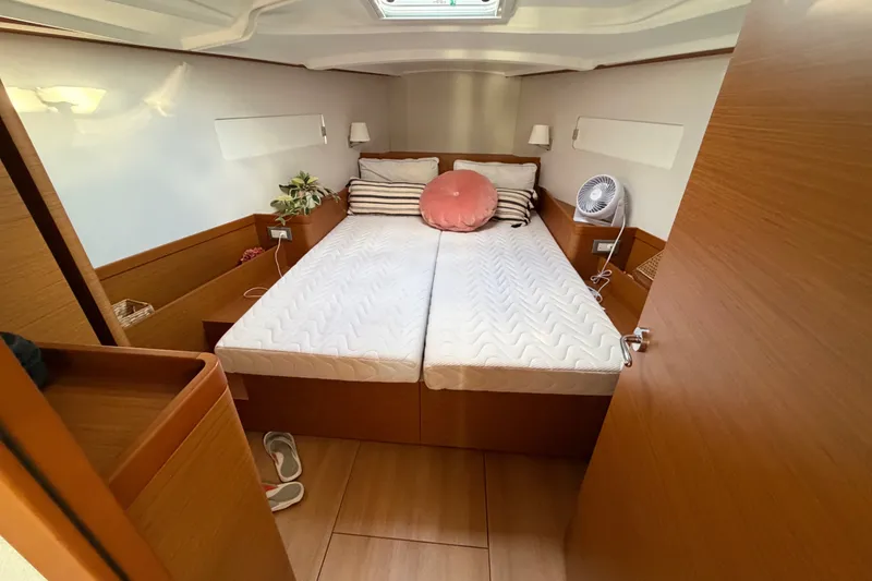 Slide: The Image of Cozy cabin interior of 2024 Jeanneau Sun Odyssey 410 sailboat with double bed. - 15
