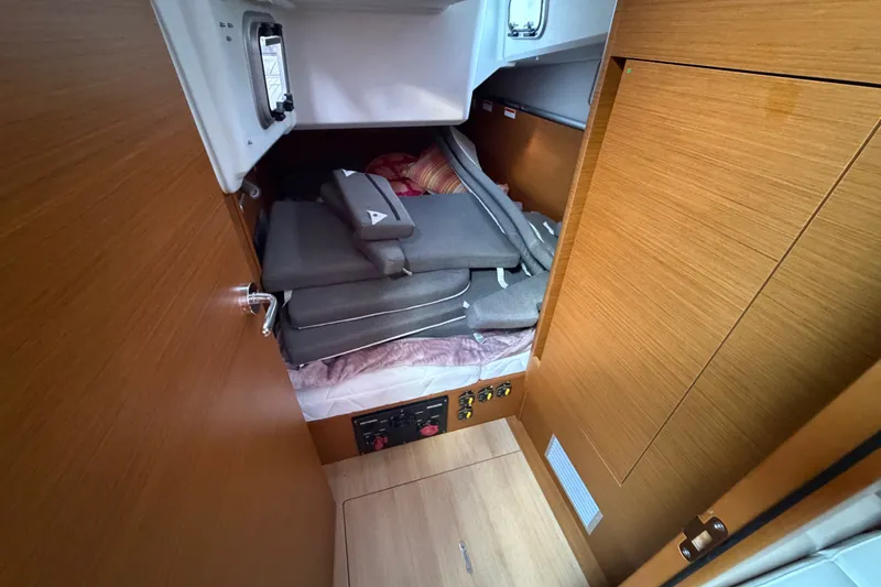 Slide: The Image of Interior cabin of 2024 Jeanneau Sun Odyssey 410 with cushions and wooden finish. - 20