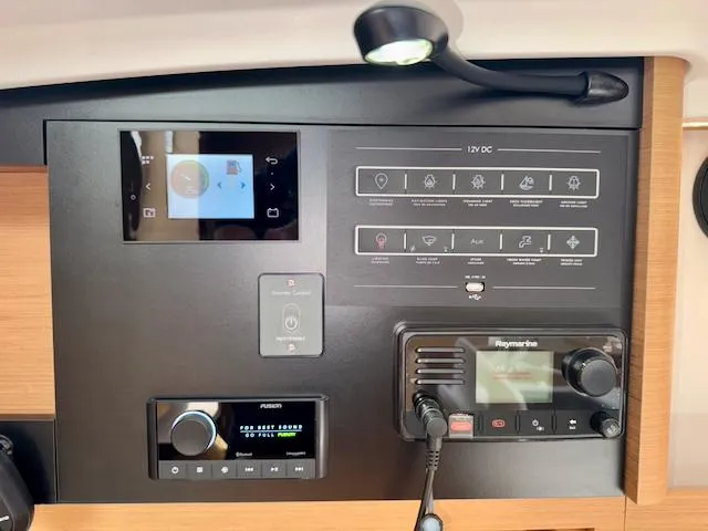 Slide: The Image of Control panel of 2024 Jeanneau Sun Odyssey 410 yacht with navigation and audio systems. - 24