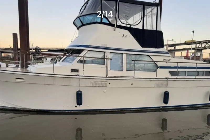 Slide: The Image of 1979 Tollycraft 40 Tri-Cabin Motor Yacht docked at marina, side view. - 0