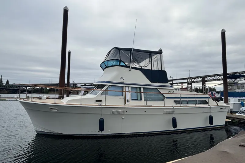 Slide: The Image of 1979 Tollycraft 40 Tri-Cabin Motor Yacht docked on a cloudy day. - 15