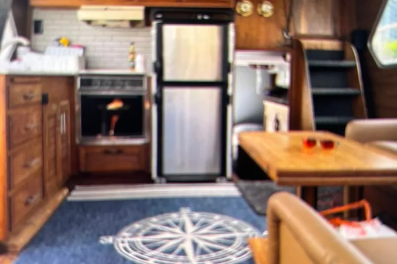 Slide: The Image of 1979 Tollycraft 40 Tri-Cabin Motor Yacht interior with kitchen and dining area. - 18