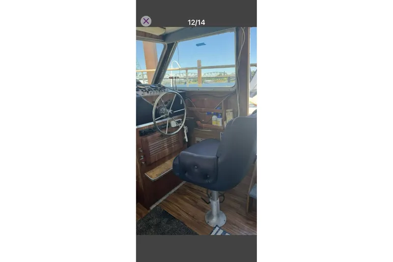 Slide: The Image of 1979 Tollycraft 40 Tri-Cabin Motor Yacht helm with steering wheel and captain's chair. - 13