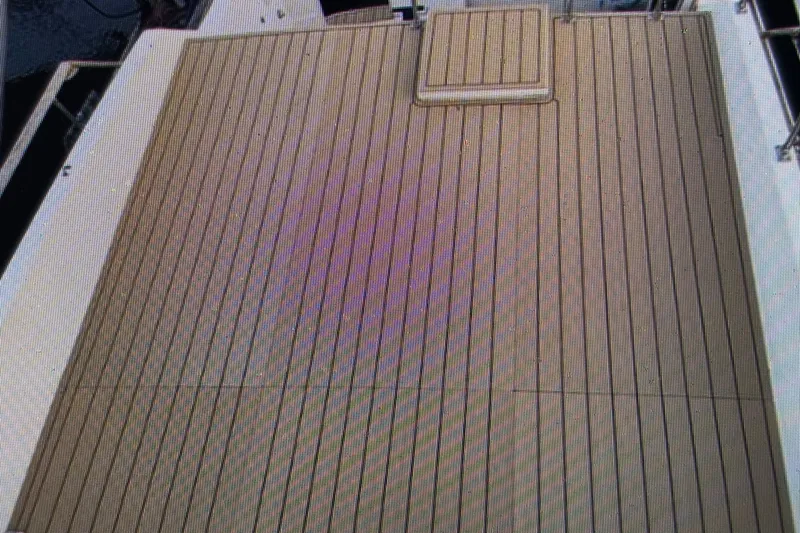 Slide: The Image of 1979 Tollycraft 40 Tri-Cabin Motor Yacht deck with wooden finish. - 16