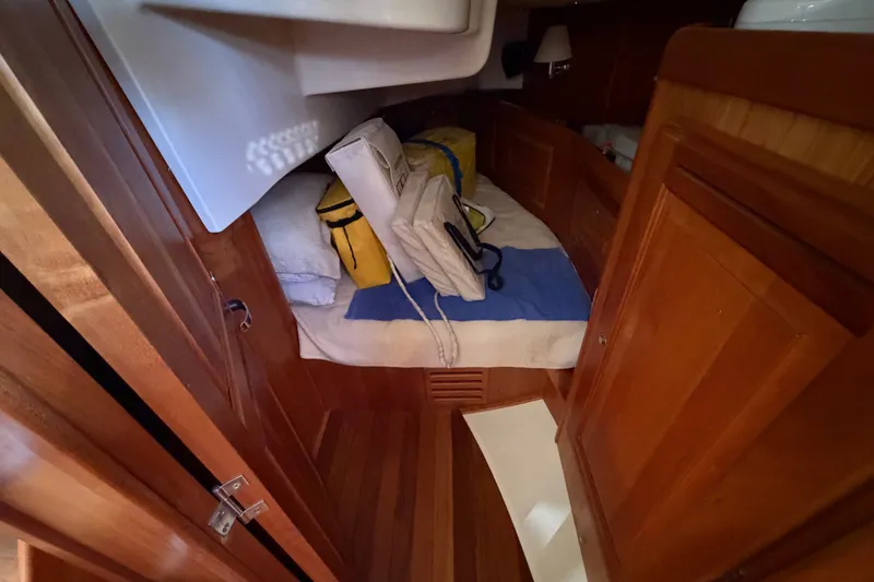 Slide: The Image of Cozy cabin interior of 2011 Tartan 4300 sailboat with wooden finish and bedding. - 20