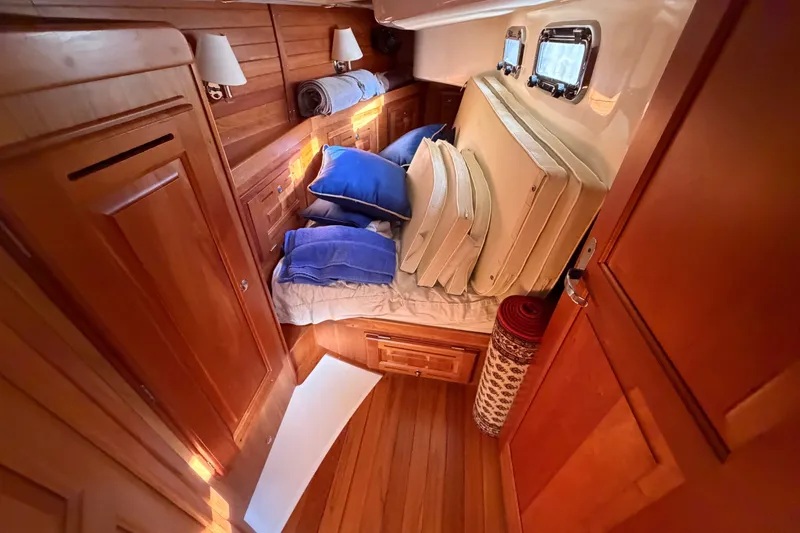 Slide: The Image of Cozy cabin interior of 2011 Tartan 4300 yacht with wooden finish and cushions. - 19