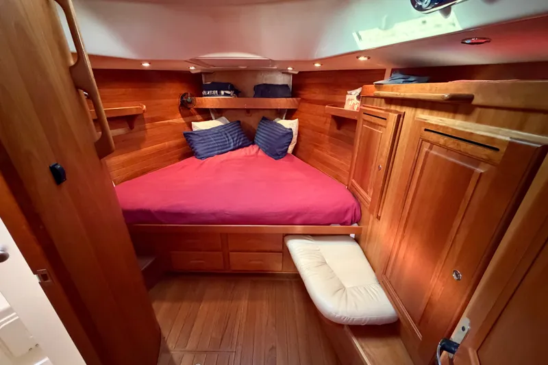 Slide: The Image of Luxurious wooden cabin interior of 2011 Tartan 4300 yacht with cozy bed and storage. - 14