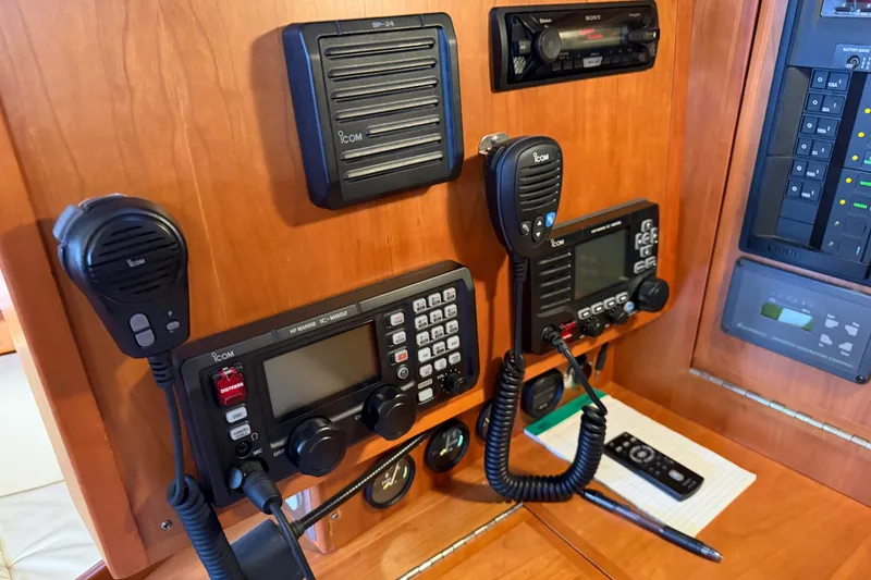 Slide: The Image of Boat communication equipment on a 2011 Tartan 4300, featuring Icom radios and control panels. - 21