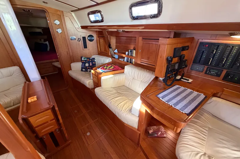 Slide: The Image of Luxurious 2011 Tartan 4300 yacht interior with plush seating and wooden cabinetry. - 13