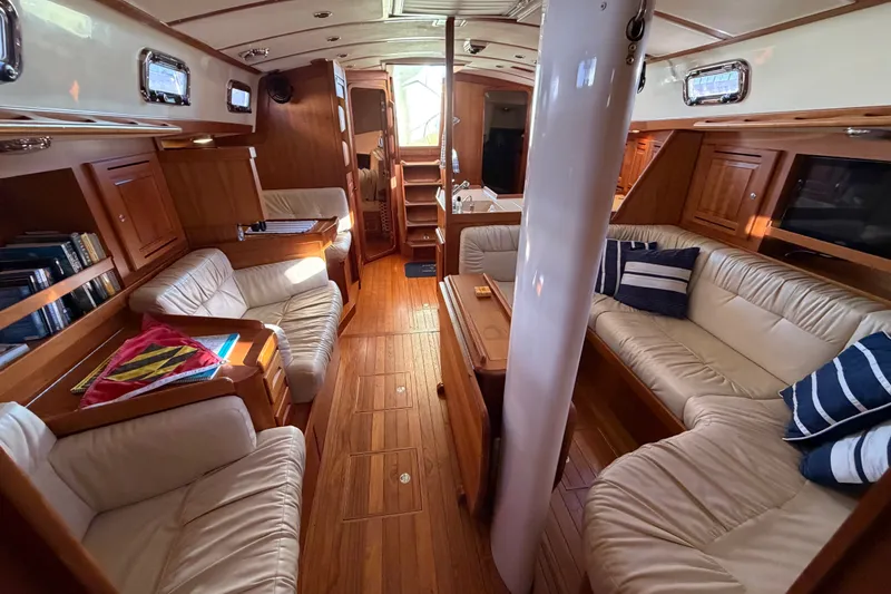 Slide: The Image of Luxurious interior of a 2011 Tartan 4300 yacht with elegant wood finish and plush seating. - 16