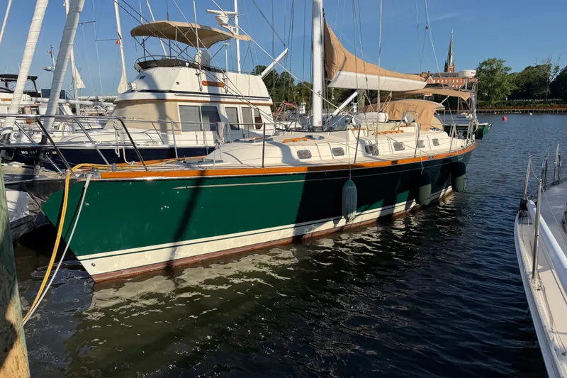 The Image of Sailboat Tartan 4300, 2011 model, docked in a marina under clear blue sky. - 0