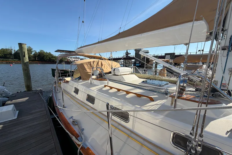 Slide: The Image of Sailboat docked at marina, Tartan 4300 model, 2011, with tan sails and clear sky. - 29