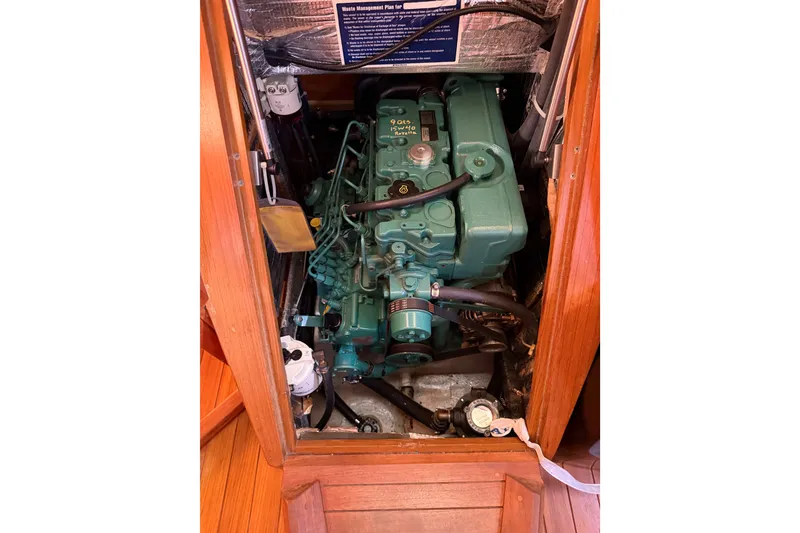 Slide: The Image of Engine compartment of a 2011 Tartan 4300 sailboat, featuring a green marine engine. - 27