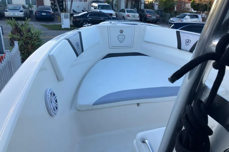 Slide: The Image of 2014 Century boat interior with cushioned seating and speaker, parked in a residential area. - 6