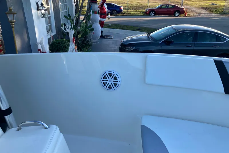 Slide: The Image of Boat interior with speaker, parked cars, and holiday decorations in the background. - 4