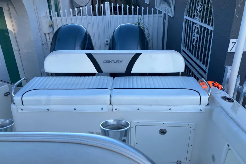 Slide: The Image of 2014 Century boat with dual engines and cushioned seating in a residential setting. - 9