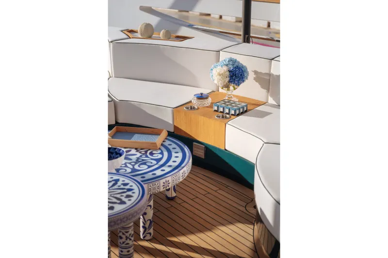Slide: The Image of Luxurious Sirena 118 yacht interior with elegant seating and decorative table, 2027 model. - 13