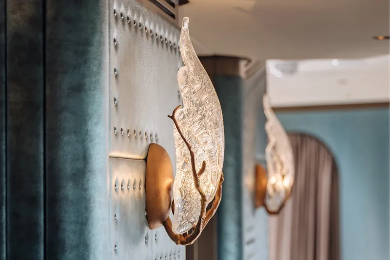 Slide: The Image of Detailed wall sconces with artistic glass designs in a luxurious interior. - 18