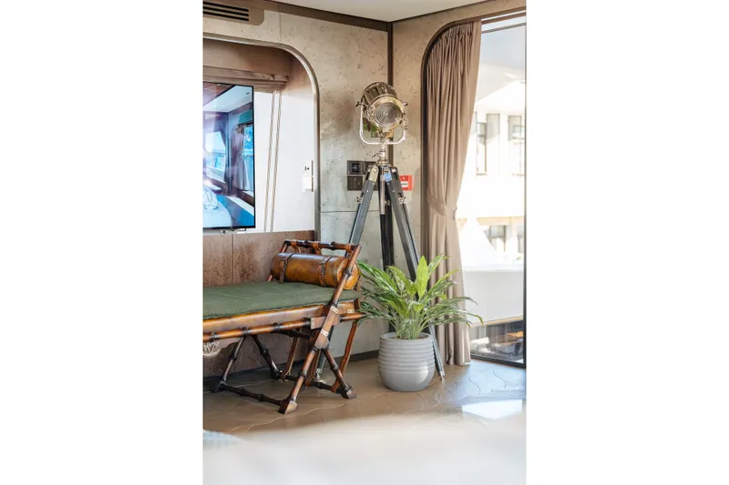 Slide: The Image of Luxurious Sirena 118 yacht interior with vintage decor, potted plant, and elegant furnishings, 2027 model. - 19