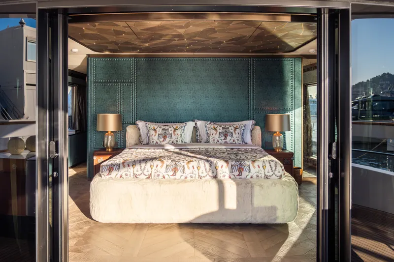 Slide: The Image of Luxurious bedroom interior on Sirena 118 yacht, 2027 model, featuring elegant decor and plush bedding. - 25